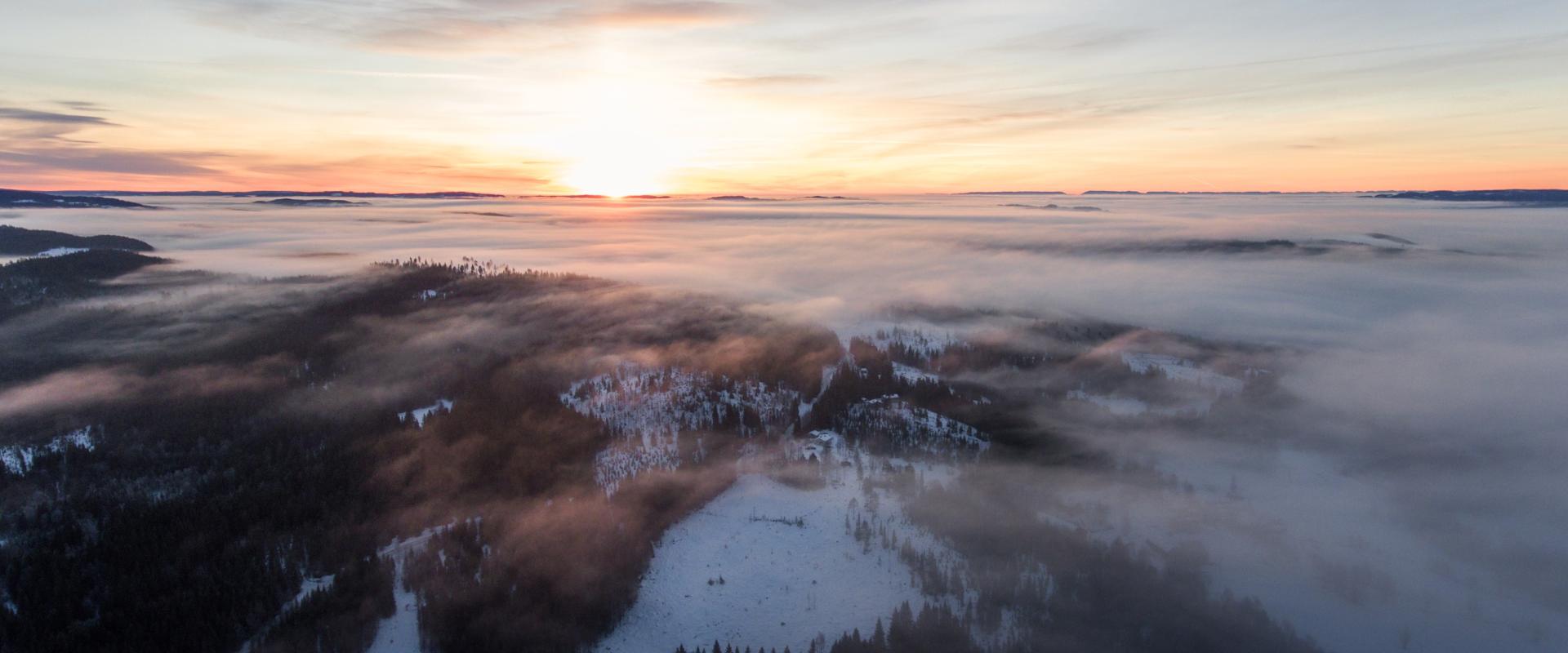 sunrise over foggy snowy morning